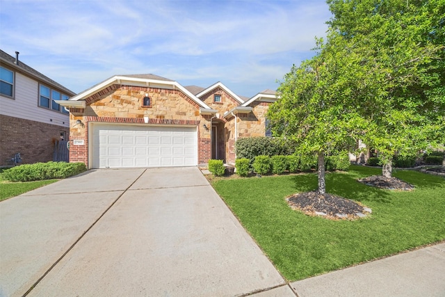 13003 Foxwood Creek Ln, Houston, TX 77044 - view of front facade with concrete driveway, stone siding, a front yard, an attached garage, and brick siding