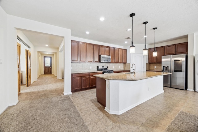 13003 Foxwood Creek Ln, Houston, TX 77044 - kitchen with stainless steel appliances, a sink, recessed lighting, backsplash, and a kitchen island with sink