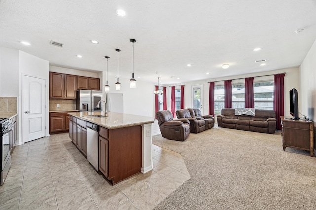 13003 Foxwood Creek Ln, Houston, TX 77044 - kitchen with stainless steel appliances, recessed lighting, light tile patterned floors, a sink, and open floor plan