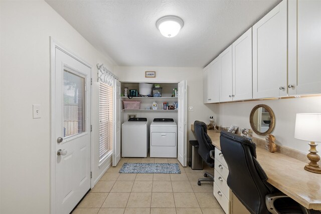 washroom with washing machine and dryer, light tile patterned floors, and a desk
