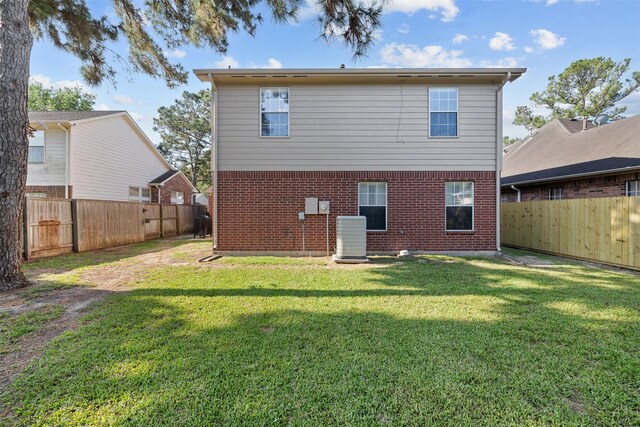 rear view of property with central AC unit and brick siding