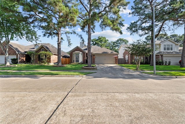 view of front of property featuring brick siding, driveway, a front yard, an attached garage, and a chimney