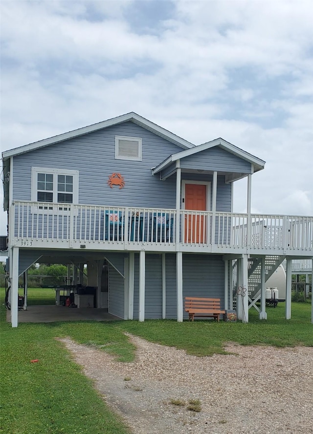 3913 1st, Galveston, TX 77554 - rear view of house with driveway, a deck, stairs, and a carport