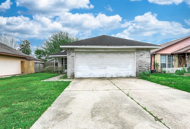 view of side of property with driveway, brick siding, and a garage