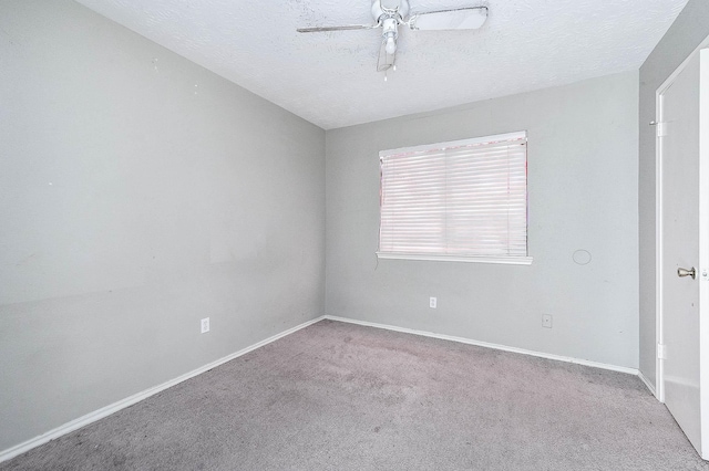 carpeted empty room featuring baseboards, a textured ceiling, and a ceiling fan