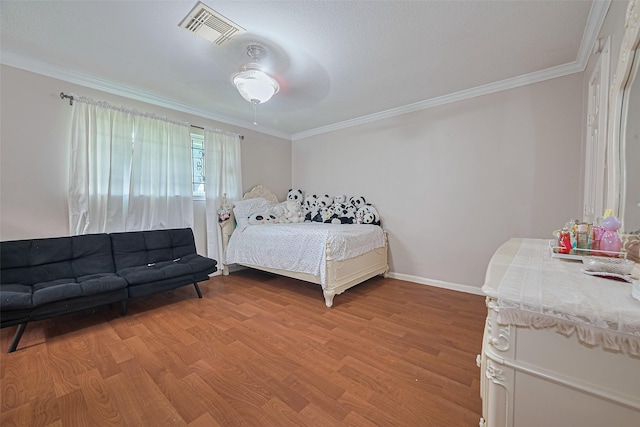 7919 Cabot St, Houston, TX 77078 - bedroom with ornamental molding, light wood-style floors, baseboards, and a ceiling fan