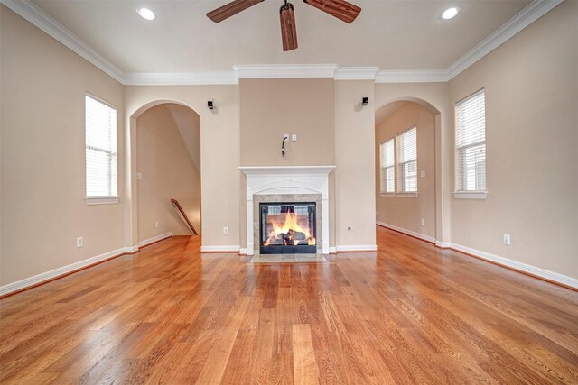 unfurnished living room with ceiling fan, light wood finished floors, crown molding, recessed lighting, and a fireplace