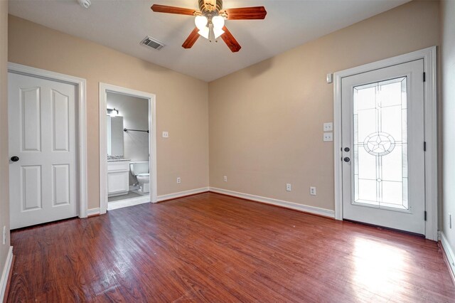 entryway featuring dark wood-style flooring, a ceiling fan, and baseboards