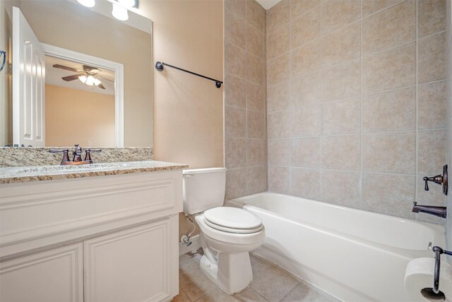 bathroom featuring a ceiling fan, toilet, vanity, washtub / shower combination, and tile patterned floors