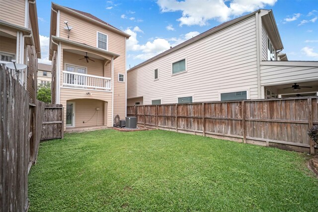 back of property with a ceiling fan, cooling unit, and a balcony