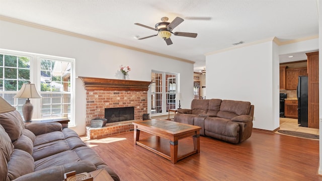 4010 Haven Pines Dr, Houston, TX 77345 - living room with ceiling fan, ornamental molding, light wood-type flooring, and a brick fireplace