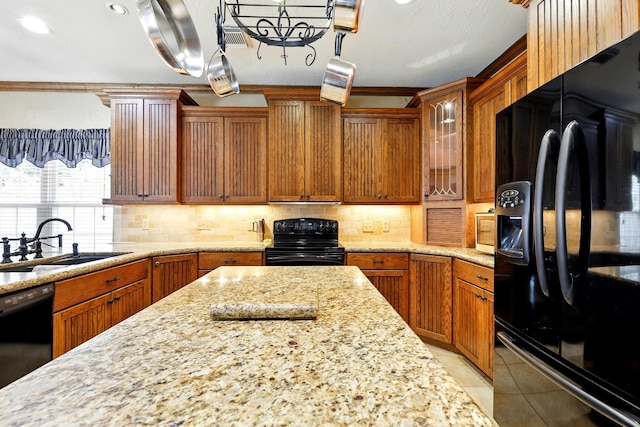 4010 Haven Pines Dr, Houston, TX 77345 - kitchen with black appliances, a sink, light stone counters, light tile patterned floors, and decorative backsplash