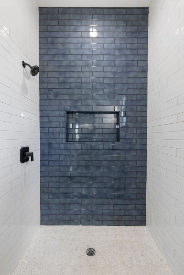 full bathroom with a tile shower