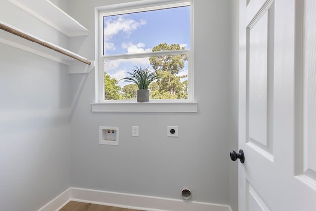 washroom featuring hookup for an electric dryer, washer hookup, baseboards, and wood finished floors