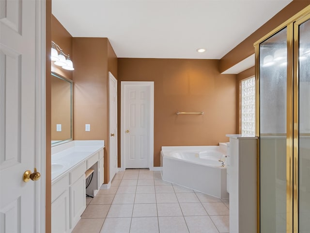 bathroom featuring a garden tub, tile patterned flooring, vanity, baseboards, and a shower with door