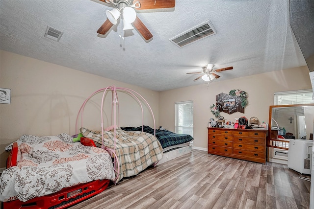 11104 Timber Crest Dr, Houston, TX 77065 - bedroom featuring wood finished floors, a textured ceiling, ceiling fan, and baseboards