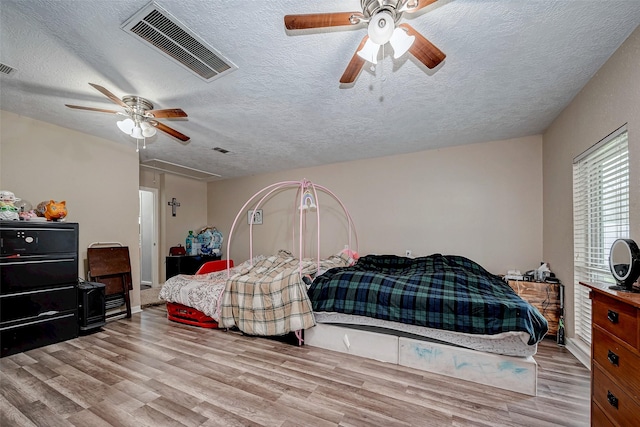 11104 Timber Crest Dr, Houston, TX 77065 - bedroom with a textured ceiling, wood finished floors, attic access, and ceiling fan