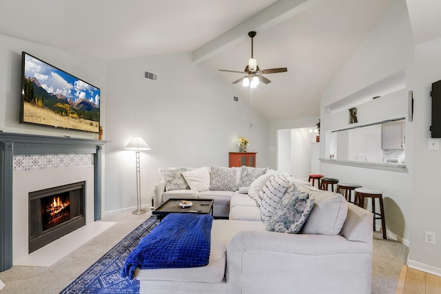 living area featuring a ceiling fan, a fireplace, and baseboards