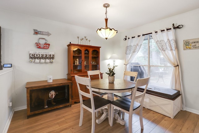 dining room with light wood-style flooring and baseboards