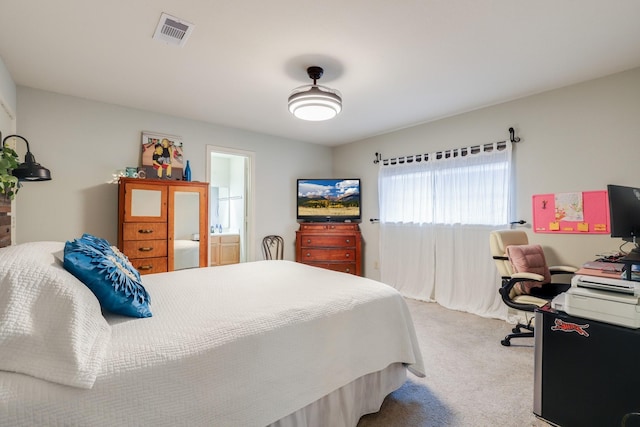 carpeted bedroom featuring an office area and connected bathroom