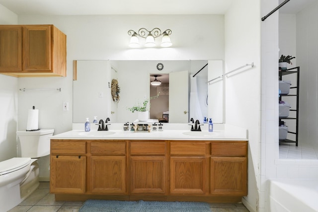 bathroom with toilet, double vanity, tile patterned floors, a bathtub, and a shower