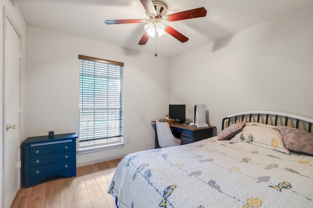 bedroom featuring wood finished floors, ceiling fan, and baseboards
