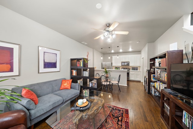 living room with dark wood-type flooring, lofted ceiling, and ceiling fan