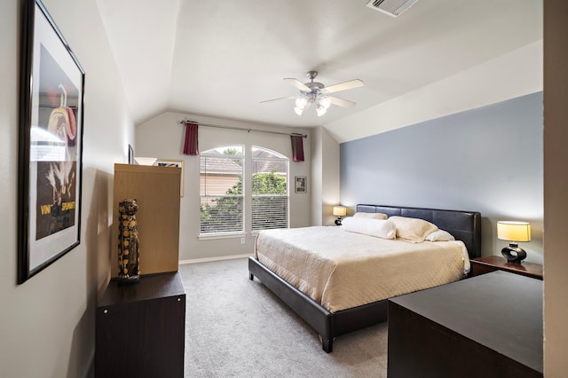 carpeted bedroom with lofted ceiling, a ceiling fan, and baseboards