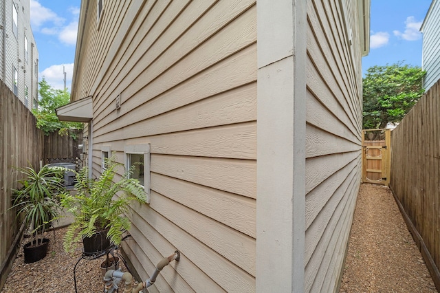 view of side of property featuring fence and cooling unit
