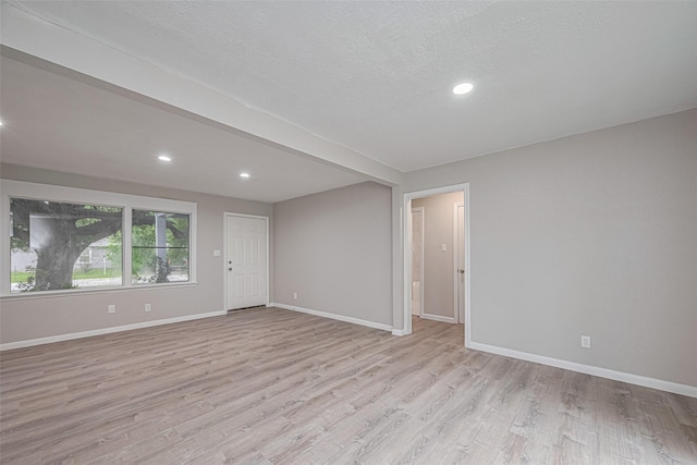 7702 Darnay Dr, Houston, TX 77033 - spare room with light wood-type flooring, baseboards, recessed lighting, and a textured ceiling