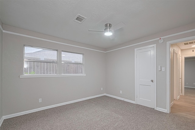 7702 Darnay Dr, Houston, TX 77033 - unfurnished room featuring ceiling fan, carpet floors, attic access, baseboards, and a textured ceiling