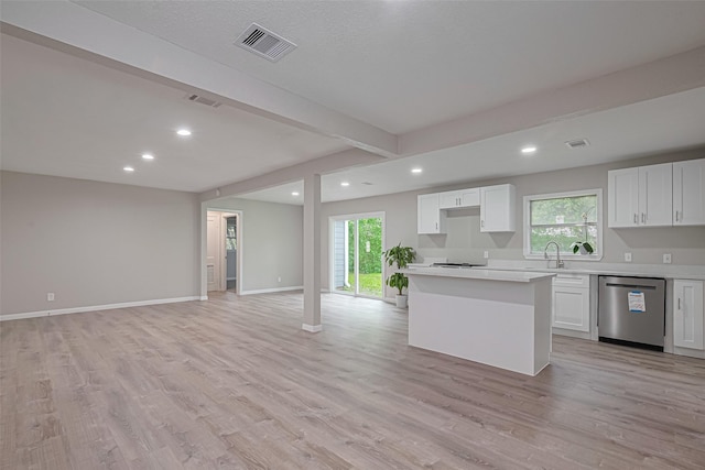 7702 Darnay Dr, Houston, TX 77033 - kitchen with dishwasher, open floor plan, recessed lighting, light countertops, and white cabinets