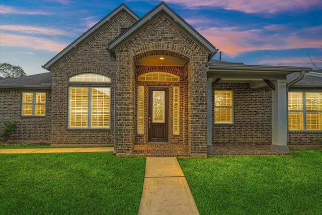 929 Oak St, Houston, TX 77018 - view of exterior entry with brick siding and a lawn