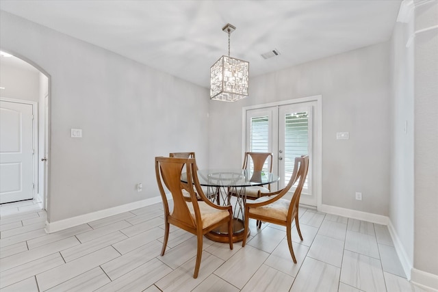 929 Oak St, Houston, TX 77018 - dining area with arched walkways, a chandelier, and baseboards