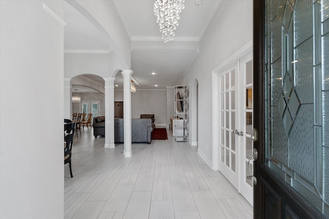 929 Oak St, Houston, TX 77018 - foyer featuring arched walkways, crown molding, a chandelier, baseboards, and ornate columns