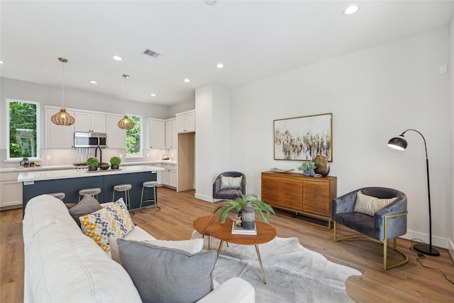 514 Janisch Rd, Houston, TX 77018 - living room with recessed lighting, light wood finished floors, and baseboards
