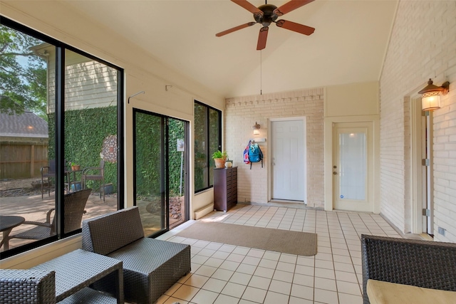 sunroom with ceiling fan and lofted ceiling