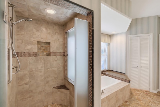 bathroom with a stall shower and a bath