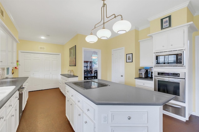kitchen featuring stainless steel appliances, a warming drawer, dark countertops, a center island, and white cabinets
