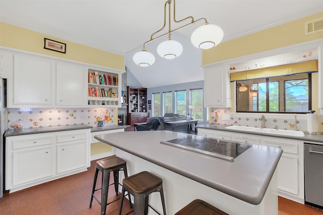 kitchen with black electric cooktop, a sink, white cabinetry, stainless steel dishwasher, and lofted ceiling