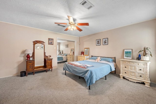 bedroom featuring carpet, a closet, ceiling fan, a textured ceiling, and baseboards