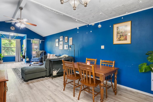 dining area featuring wood finished floors, a ceiling fan, lofted ceiling, baseboards, and a chandelier