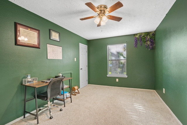 office with a textured ceiling, carpet floors, a ceiling fan, and baseboards