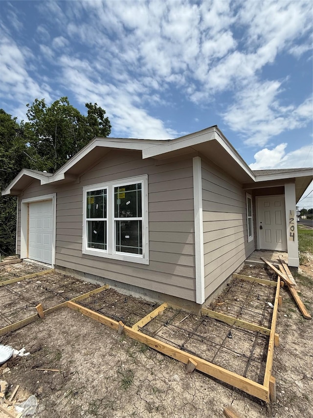 view of property exterior featuring an attached garage