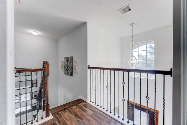 81 San Simeon Dr, Manvel, TX 77578 - hall with dark wood-type flooring, an upstairs landing, baseboards, and a textured ceiling