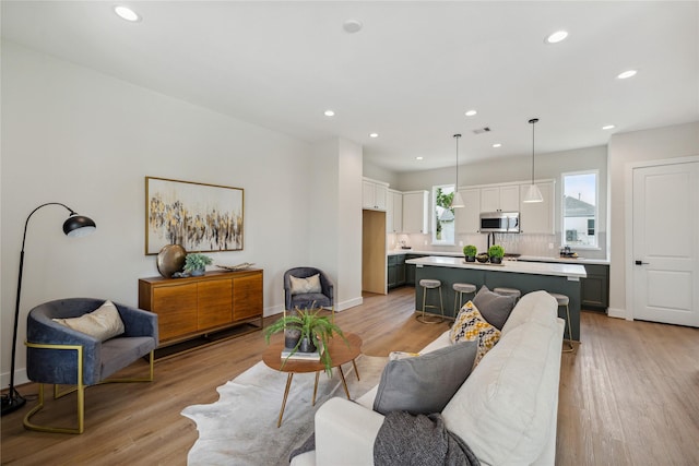 524 Janisch Rd, Houston, TX 77018 - living area featuring recessed lighting, light wood-type flooring, and baseboards