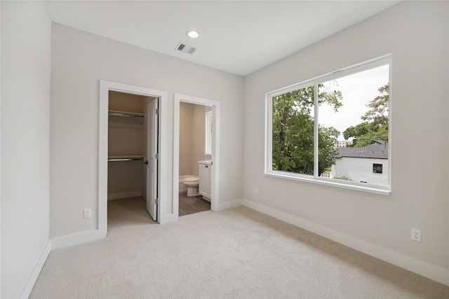 524 Janisch Rd, Houston, TX 77018 - unfurnished bedroom with a spacious closet, carpet, baseboards, ensuite bathroom, and a closet