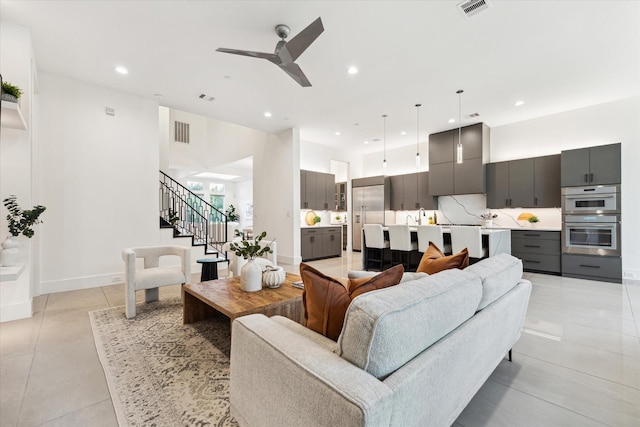 living room with recessed lighting, stairs, ceiling fan, light tile patterned floors, and baseboards