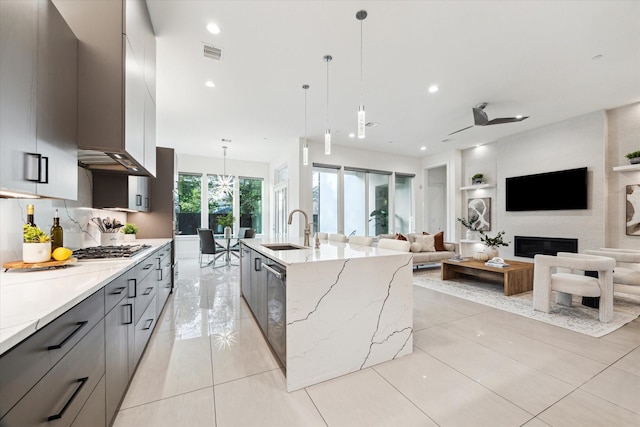 kitchen featuring a sink, modern cabinets, gray cabinets, stainless steel appliances, and recessed lighting