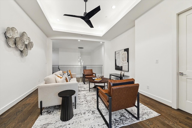 living room featuring ceiling fan, wood finished floors, recessed lighting, baseboards, and a raised ceiling